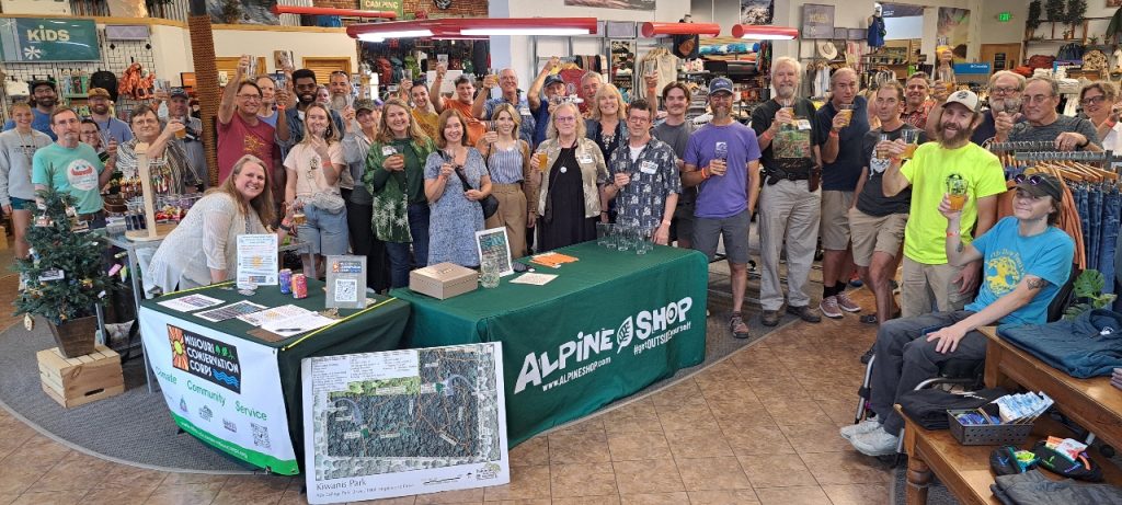 Friends and supporters raise a glass at the 2024 Al-Pint Night fundraiser at the Alpine Shop.